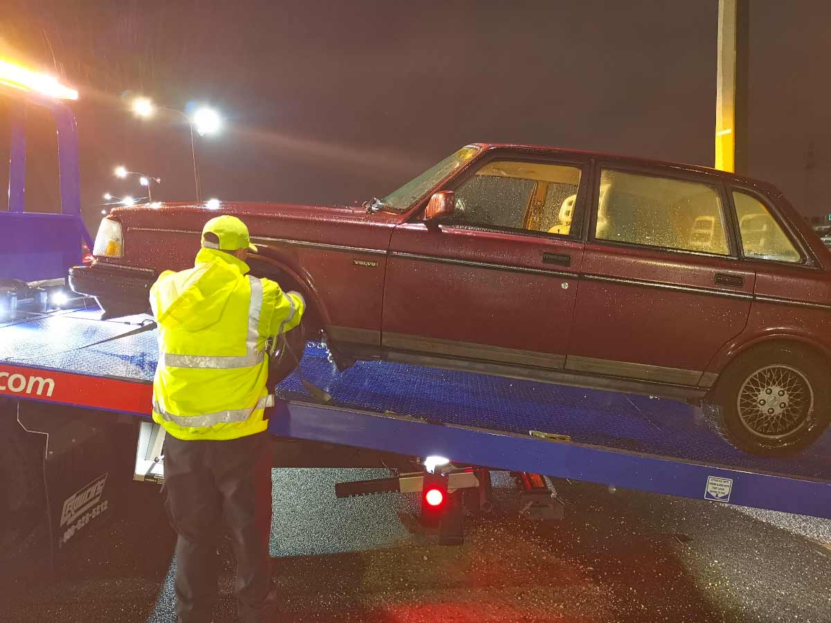 Volvo 240 being towed